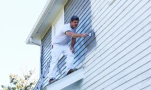 man doing residential exterior painting